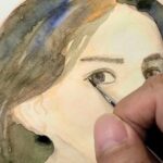 透明水彩で描いている途中の人物の顔アップ