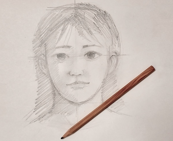 顔の比率の補助線に合わせて描いた鉛筆画のスケッチ